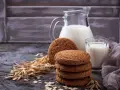 Biscotti farina di avena friabilissimi, perfetti con un bicchiere di latte fresco. Un'immagine che evoca colazioni genuine e momenti di puro piacere.