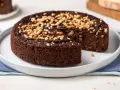 Torta paesana al cioccolato, ricca e umida, guarnita con pinoli tostati. Un dolce rustico che sa di casa.