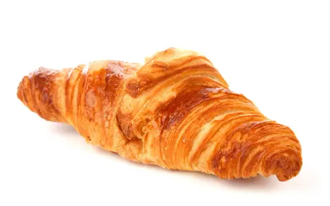 Un delizioso croissant francese, dorato e sfogliato, pronto per una colazione da sogno.