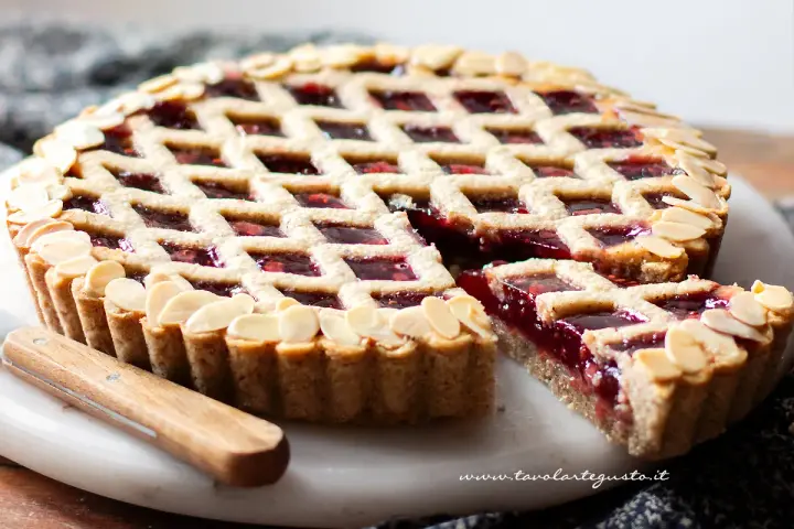 Torta Linzer ricetta originale: crostata con marmellata di lamponi e mandorle a lamelle, un classico della pasticceria.